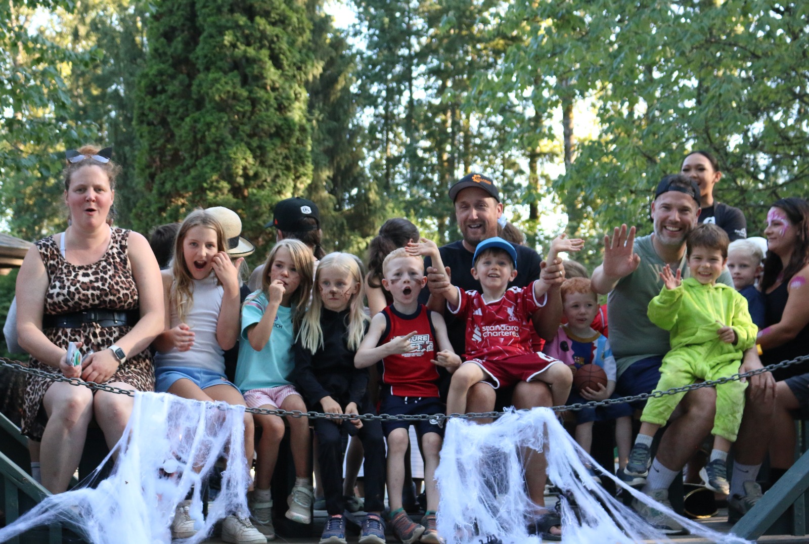 Families seated on a cobweb-decorated wagon ride at the campground