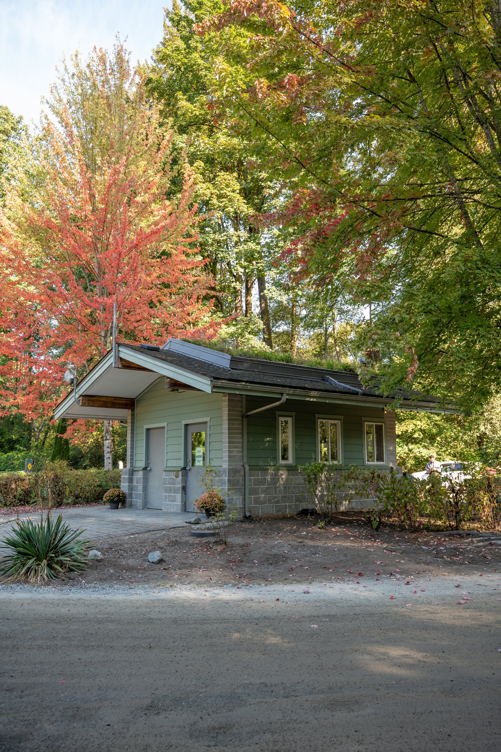 Park building under red and gold maples at Fort Camping