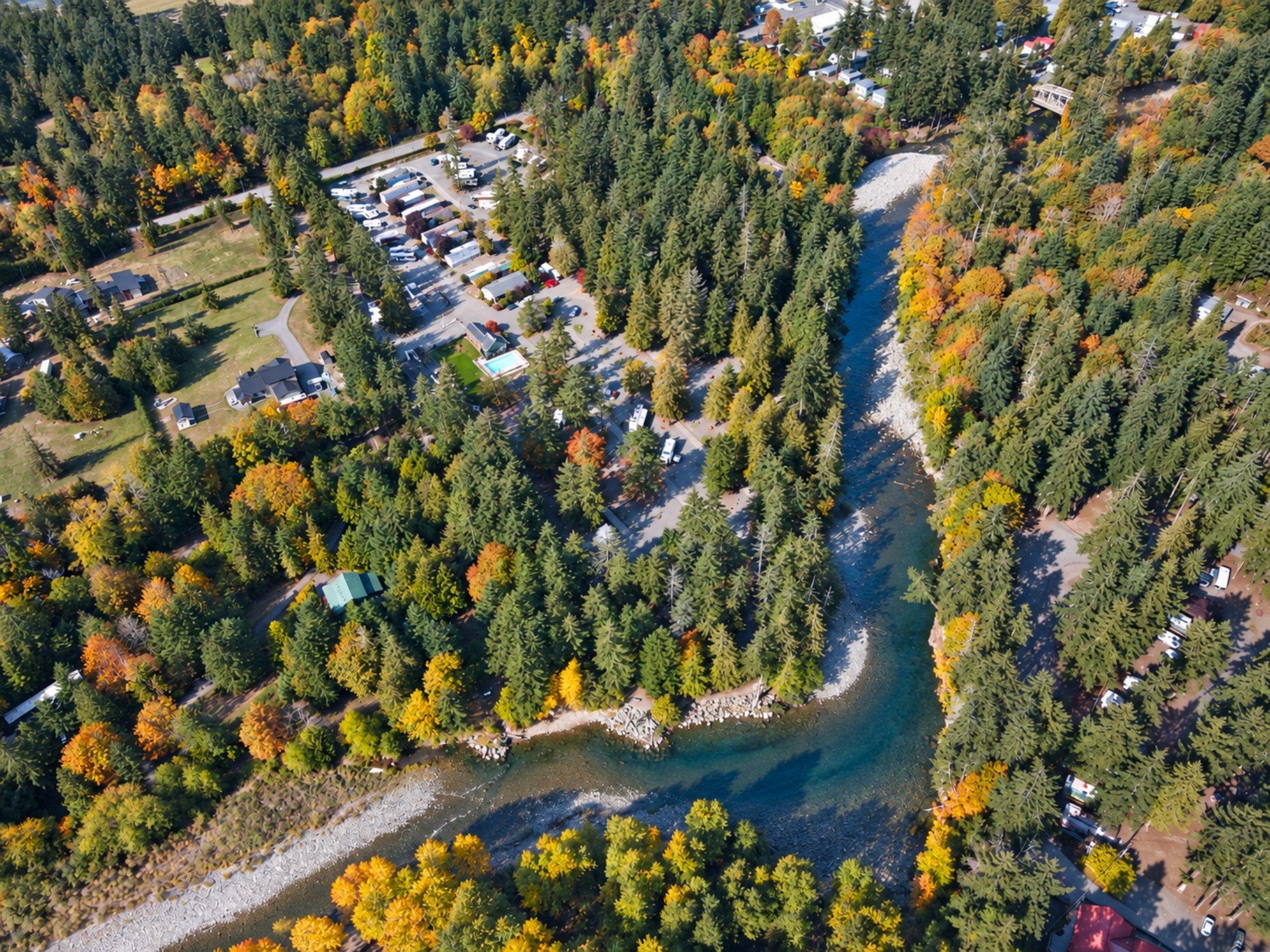 The Englishman River bending past Pathfinder Parksville in the fall, from above